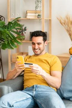 Young man with mobile phone checking his bank statement. Stock Photos