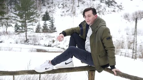 A Young Man Model posing in a Snowy Winter Forest with Nike Sneakers Stock Footage 147439602