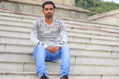 Young man model sitting on the step Stock-Fotos