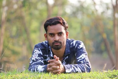 Young man model sleeping on a grass field Foto stock