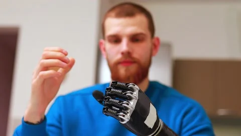 Young man with modern biotechnology hand in apartment Video stock 146449780