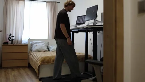 Young man monitors financial charts while walking during remote computer work Stock Footage 346881953