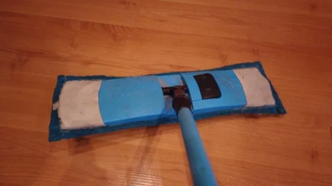 Young man with Mop, Cleaning Floor at Home. Man Sweeps Dust in room and brings Stock Footage 106464453
