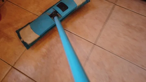 Young man with Mop, Cleaning Floor at Home. Man Sweeps Dust in room and brings Stock Footage 106472501