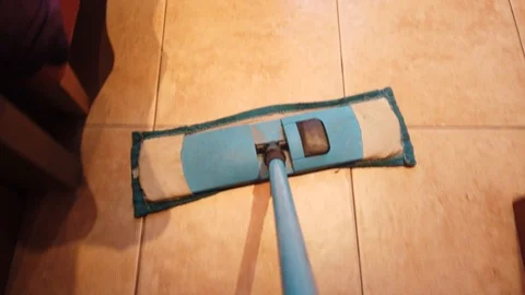 Young man with Mop, Cleaning Floor at Home. Man Sweeps Dust in room and brings Stock Footage 106472571