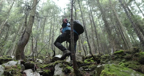 A young man in a mountain hiking with a backpack Stock-Footage 243723055