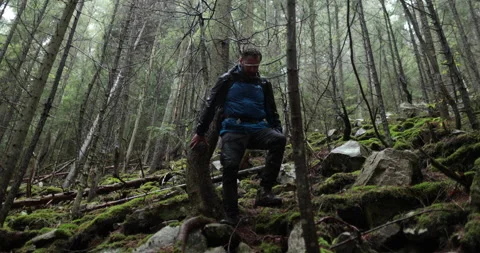 A young man in a mountain hiking with a backpack Stock Footage 243731423