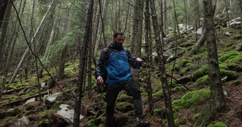 A young man in a mountain hiking with a backpack Stock Footage 243734127