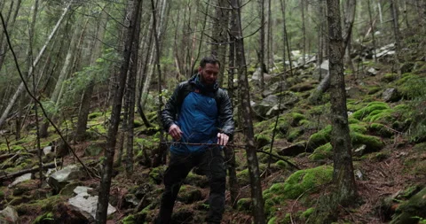 A young man in a mountain hiking with a backpack Stock Footage 243734802