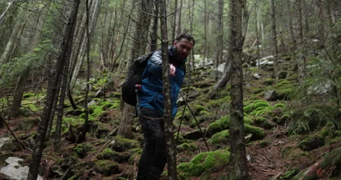 A young man in a mountain hiking with a backpack Stock Footage 243735120