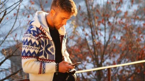 Young man in at mountain using cell phone Stock Photos