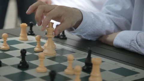 Young Man Moving Chess Piece on Board Outdoors Stock Footage 341323716
