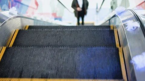 Young man moving on escalator, goes up the escalator in a big business center Video stock 101233629