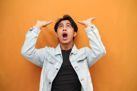 Young man moving head feeling heavy isolated on yellow background Stock Photos