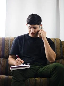 Young man multitasking Stock Photos