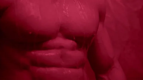 Young man muscular guy bodybuilder on which water pours Portrait of Sexy Male Video stock 239554456