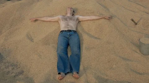 Young man with naked torso falls in harvested grain of wheat Stock Footage 66931237