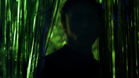 Young Man In Nightclub. Lighting Changes In Different Colors. Stock-Footage 179566910