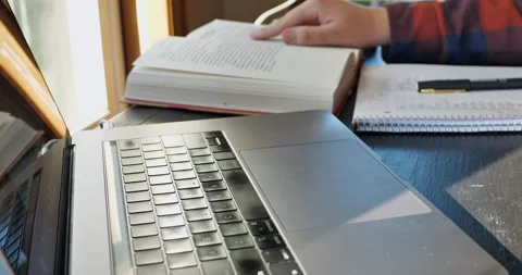 Young man with notebook, book, and laptop. Video stock 141231325