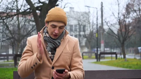 Young man obsessed with his smart phone isolated on a white background Stock Footage 165827232