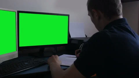 Young man at office green screen monitors Stock Footage 55533760