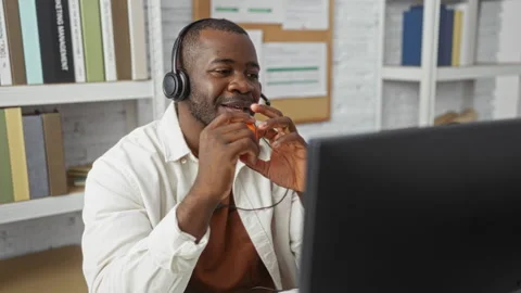 Young man in office using stress ball while on video call, wearing headphon.. Stock Footage 297607351