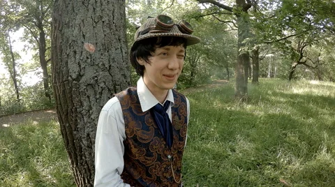 Young man in old-fashioned clothes smokes cigarette 動画素材 65881698