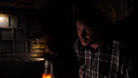 A young man in an old house lights a path with a kerosene lamp Stock Footage 136852437