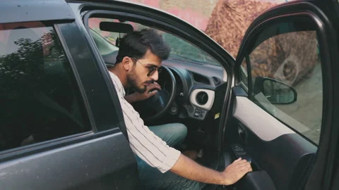 Young man open car side door look forward &amp; backward then close door Stock Footage 138482885