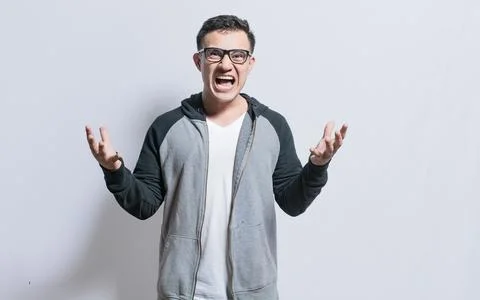 Young man with open hands screaming angry to the camera, Irritated person s.. Stock Photos