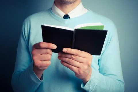 Young man with open notebook Stock Photos