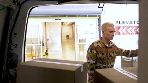 Young man opening back of moving van full of cardboard boxes Stock Footage 221037763