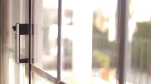 Young man opening balcony sliding window door 4k Stock Footage 90360829