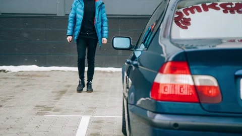 Young man opening car door and sitting in the car Stock Footage 86132397