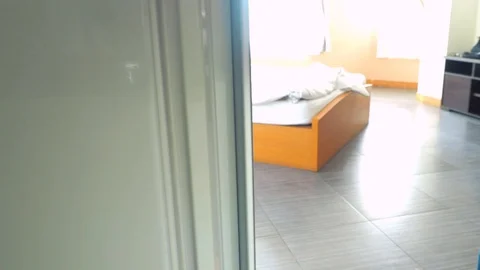 A young man opening fridge then take water bottle and glass off from fridge. Stock Footage 111134757