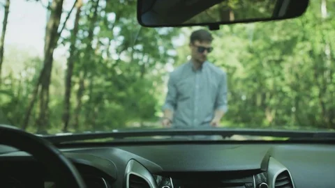 Young Man Opening the Hood. View From the Car Stock Footage 79736687