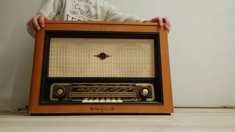 Young man opens and closes radio gramophone. Stock Footage 70763489