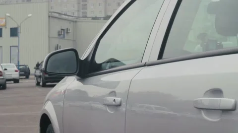 A young man opens the car and sit in it. Stock-Footage 54336335