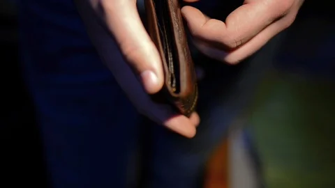 Young man opens the empty wallet Stock Footage 99790309