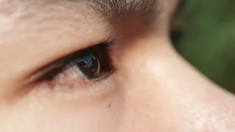 Young man with opens his eyes, brown eyes, close-up and slow motion Video stock 155335837