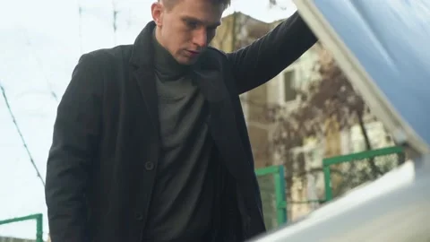 Young man opens the hood of his car. car breakdown. close-up. Stock Footage 233355507