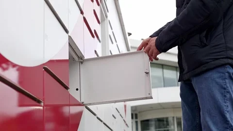 The young man opens the mailbox and takes the package. Stock Footage 263591151