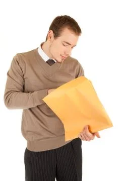 Young man opens a post package Stock Photos