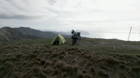 A young man operates the drone from his tent for social media Stock Footage 270972077