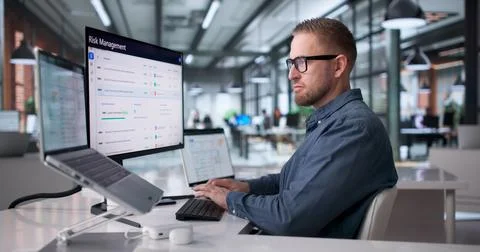 Young Man Operating ERP System On Laptop For Business Resource Management Stock Photos