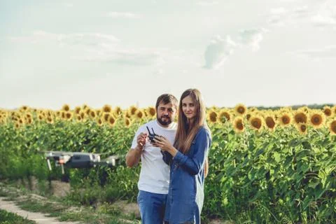 Young man operating of flying drone octocopter at the green field. Stock Photos