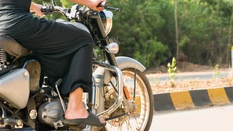 Young man operating a motorcycle a side view Stock Photos