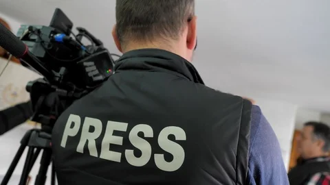 The young man, the operator takes on camera the reportage. press jacket Stock Footage 124702981