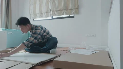 Young Man Organizing Papers and Materials at Home Stock Footage 314995898