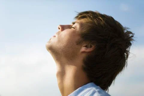 Young man outdoors with head back, eyes closed Fotos Stock